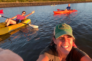 Three people kayaking on a sunny day.