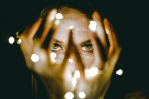 Woman holding lights Photo by Rhett Wesley on Unsplash